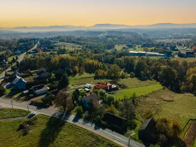 an aerial view of a small town with houses and trees at Dom pod Lipą in Łyczanka