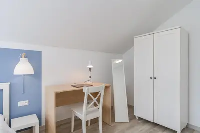 a small room with a desk and a white cabinet at Dom pod Lipą in Łyczanka