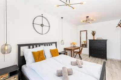a bedroom with a large bed with yellow pillows at Dom pod Lipą in Łyczanka
