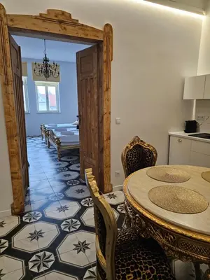 a dining room with a table and chairs at Juwel Apartments Kraków z widokiem na Wawel ap 29A in Kraków