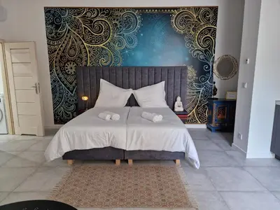 a bedroom with a bed with two towels on it at JUWEL Apartments Kraków Indyjski ap 29 in Kraków