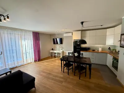 a bedroom with a bed and a lamp and wooden floors at Browar Lubicz- 5min walk to the Old Town, GARAGE in Kraków