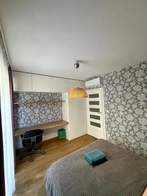 a bedroom with a bed and a chair and a window at Browar Lubicz- 5min walk to the Old Town, GARAGE in Kraków