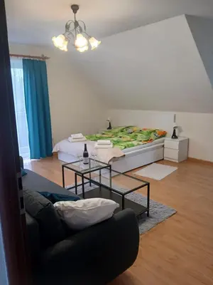 a living room with a bed and a couch at Zielony Gaj in Gaj