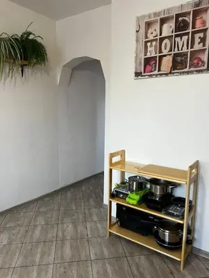 a room with a shelf with pots and pans at Zielony Gaj in Gaj