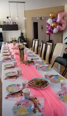 a long table with plates of food and balloons at Zielony Gaj in Gaj