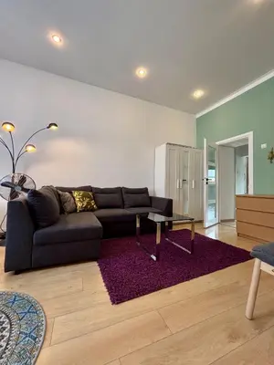 a living room with a couch and a table at Vintage Senacka 9/7 Apartment in Kraków