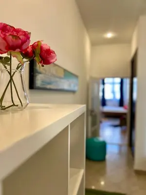 a vase with pink flowers sitting on a counter at Vintage Senacka 9/7 Apartment in Kraków