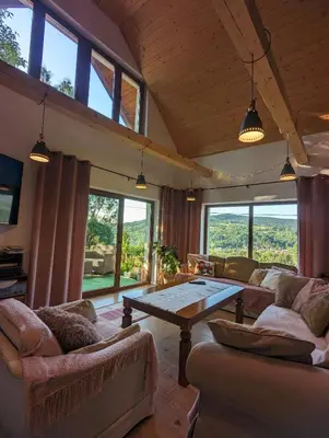 a living room with two couches and a table at Makowy domek in Maków Podhalański