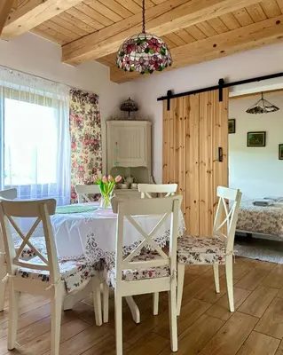 a room with a table and chairs and a bedroom at Makowy domek in Maków Podhalański