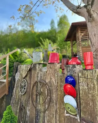 a wooden fence with different colored bowls on it at Makowy domek in Maków Podhalański