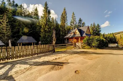 a wooden fence in front of a wooden house at Bacówka Polanki in Obidowa