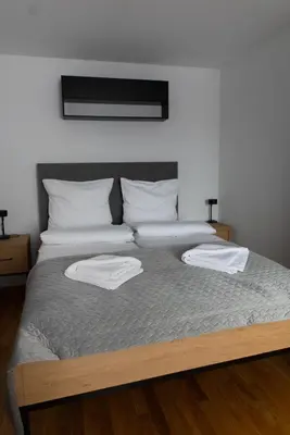 a bed with two white towels on top of it at Apartamenty Loftove in Wadowice