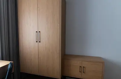a cupboard and a wooden cabinet in a room at Apartamenty Loftove in Wadowice