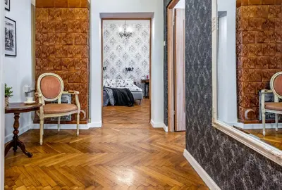 a hallway with two chairs and a table and a bedroom at Apartament tuż przy Wawelu in Kraków