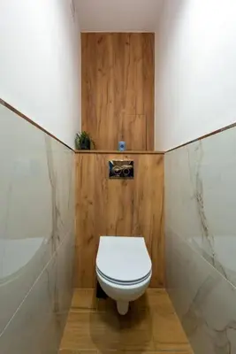 a bathroom with a white toilet and a shower at Apartament tuż przy Wawelu in Kraków