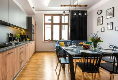 a kitchen and dining room with a table and chairs at Apartament tuż przy Wawelu in Kraków