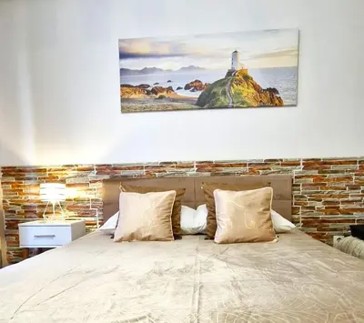 a bedroom with a bed with a lighthouse on a rock at Modern Apartment SANDY BEACH down town, aquapark, free parking in Kraków