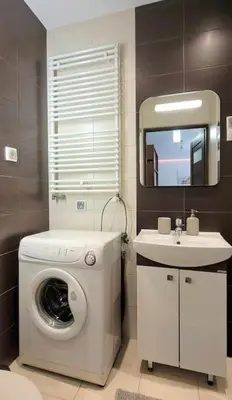 a bathroom with a washing machine and a sink at Modern Apartment SANDY BEACH down town, aquapark, free parking in Kraków