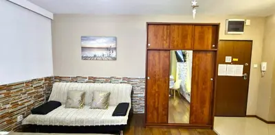 a living room with a couch and a door at Modern Apartment SANDY BEACH down town, aquapark, free parking in Kraków