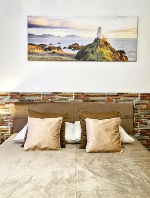 a bedroom with a large bed with a painting on the wall at Modern Apartment SANDY BEACH down town, aquapark, free parking in Kraków