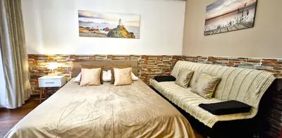 a bedroom with a large bed and a couch at Modern Apartment SANDY BEACH down town, aquapark, free parking in Kraków