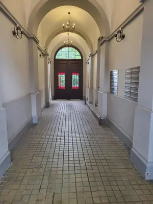 an empty hallway with a large door and windows at Grzegorzecka Room nr 2 in Kraków