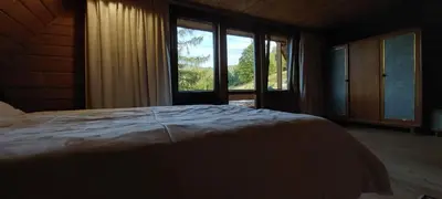 a bedroom with a bed and a large window at 650m n.p.m. in Zawoja
