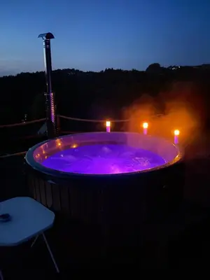 a hot tub with two candles in it at night at 650m n.p.m. in Zawoja