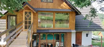 an exterior view of a house with a large window at 650m n.p.m. in Zawoja