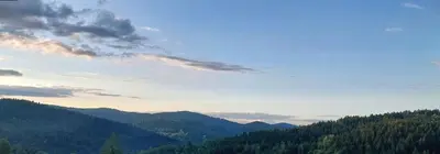 a view of a mountain with trees and a sky at 650m n.p.m. in Zawoja