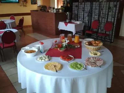 a white table with food on top of it at Zajazd Skorpion B&B in Oświęcim