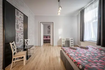 a room with a dining table and a bed in it at 70s Hostel in Kraków