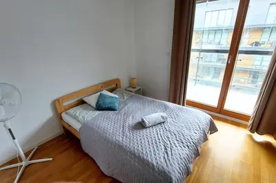a bedroom with a bed with two pillows and a window at Masarska Family Apartment free Parking in Kraków