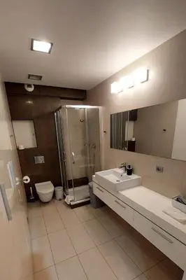 a bathroom with a sink and a shower and a toilet at Masarska Family Apartment free Parking in Kraków