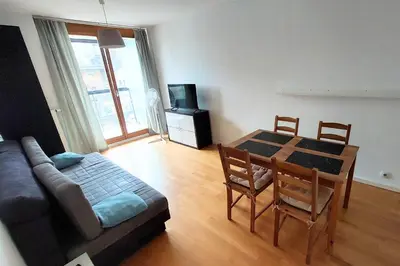 a living room with a table and a couch at Masarska Family Apartment free Parking in Kraków