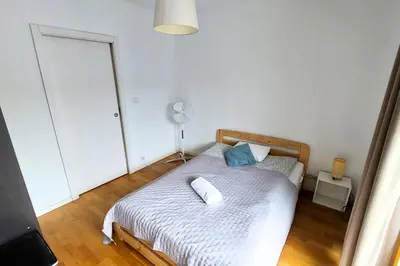 a bedroom with a bed with two pillows on it at Masarska Family Apartment free Parking in Kraków