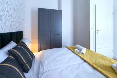 a bedroom with a bed with a wooden tray on it at Zabłocie Residence in Kraków