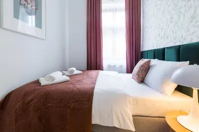 a bedroom with a bed with two towels on it at Zabłocie Residence in Kraków