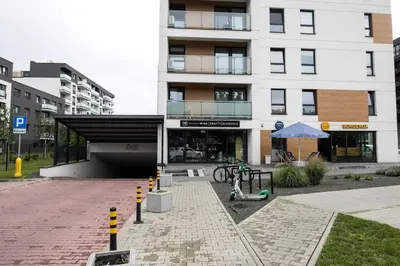 a building with a playground in front of it at Nowoczesny Apartament Dąbska Arena / Parking in Kraków