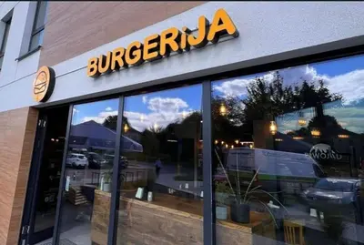 a store with a sign on the front of it at Nowoczesny Apartament Dąbska Arena / Parking in Kraków