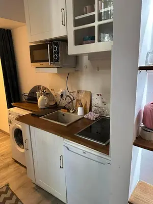a small kitchen with white cabinets and a sink at City Centre Apartment Wielopole in Kraków