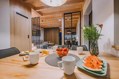 a dining room table with a plate of fruit on it at Słone Wzgórze in Rabka