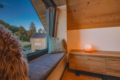 a window seat in a tiny house with a view at Słone Wzgórze in Rabka