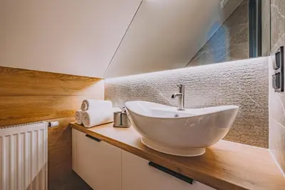 a bathroom with a white sink on a wooden counter at Słone Wzgórze in Rabka