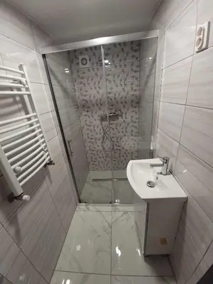 a bathroom with a shower and a sink at Apartamenty Kącik 8 in Kraków