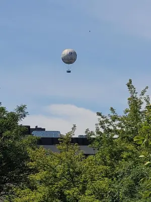 a hot air balloon in the sky over trees at Apartamenty Kącik 8 in Kraków