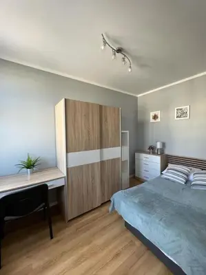a bedroom with a bed and a desk in it at Walenty Kraków in Kraków