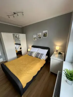 a bedroom with a bed with a yellow blanket at Walenty Kraków in Kraków