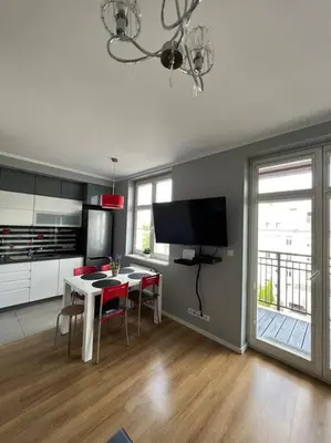 a kitchen and dining room with a table and chairs at Walenty Kraków in Kraków